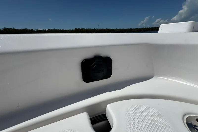 Slide: The Image of 2025 Blackwater 23 Bay boat interior detail with sleek white finish and plug socket. - 15