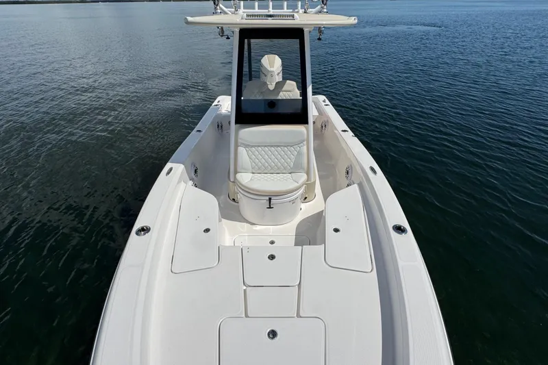 Slide: The Image of 2025 Blackwater 23 Bay boat on calm water, showcasing sleek design and spacious deck. - 17