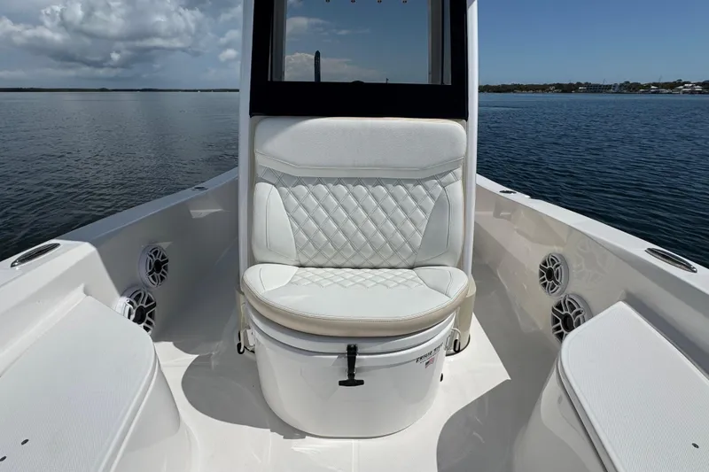 Slide: The Image of 2025 Blackwater 23 Bay boat interior with cushioned seating and ocean view. - 18