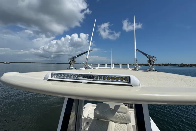 Slide: The Image of 2025 Blackwater 23 Bay boat with antennas and LED light bar on calm water. - 21