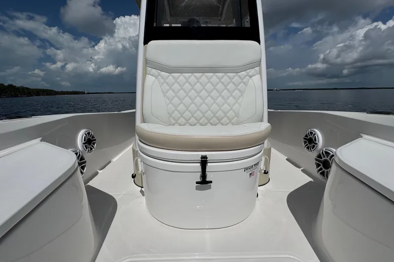 Slide: The Image of 2025 Blackwater 23 Bay boat interior with cushioned seating and marine speakers on a sunny day. - 23