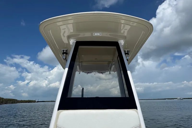 Slide: The Image of 2025 Blackwater 23 Bay boat console under a clear blue sky. - 24