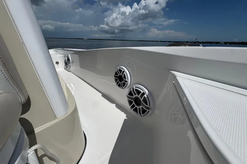 Slide: The Image of 2025 Blackwater 23 Bay boat interior with speakers, under a partly cloudy sky. - 26