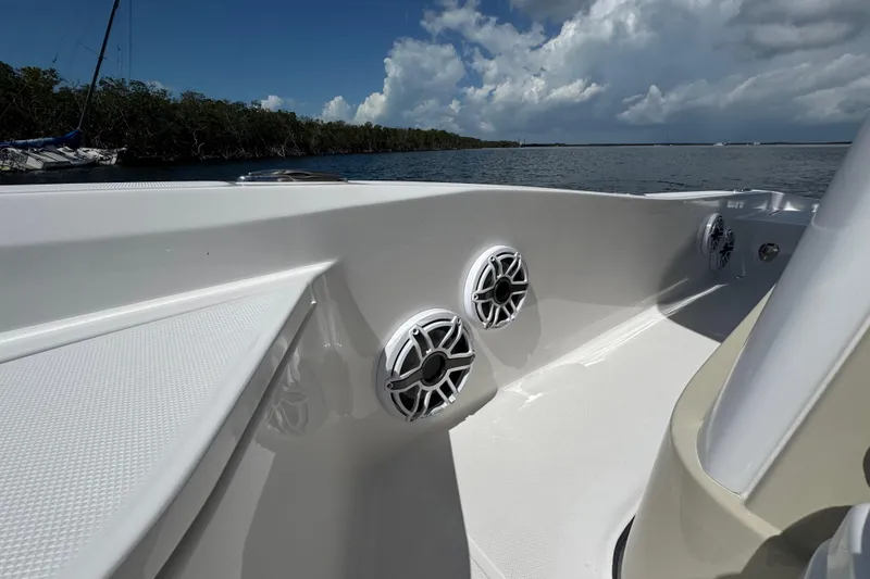 Slide: The Image of 2025 Blackwater 23 Bay boat interior with speakers, on a sunny day by the water. - 27