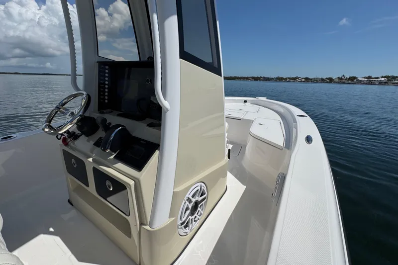 Slide: The Image of 2025 Blackwater 23 Bay boat interior with steering console on calm water. - 31