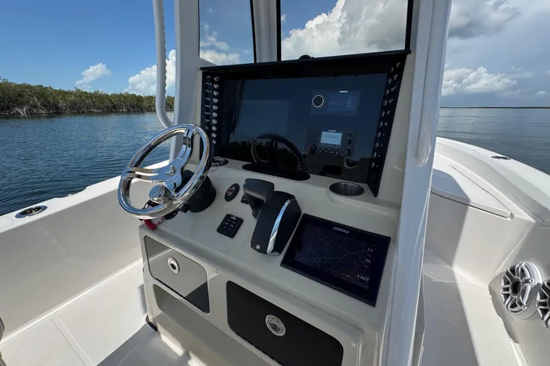 Slide: The Image of 2025 Blackwater 23 Bay boat console with steering wheel and navigation system. - 38