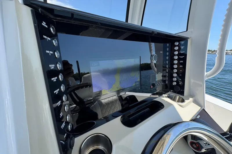 Slide: The Image of 2025 Blackwater 23 Bay boat dashboard with navigation screen and control panel. - 41