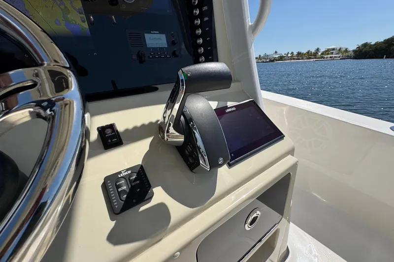 Slide: The Image of Control panel of 2025 Blackwater 23 Bay boat with navigation and throttle controls. - 42