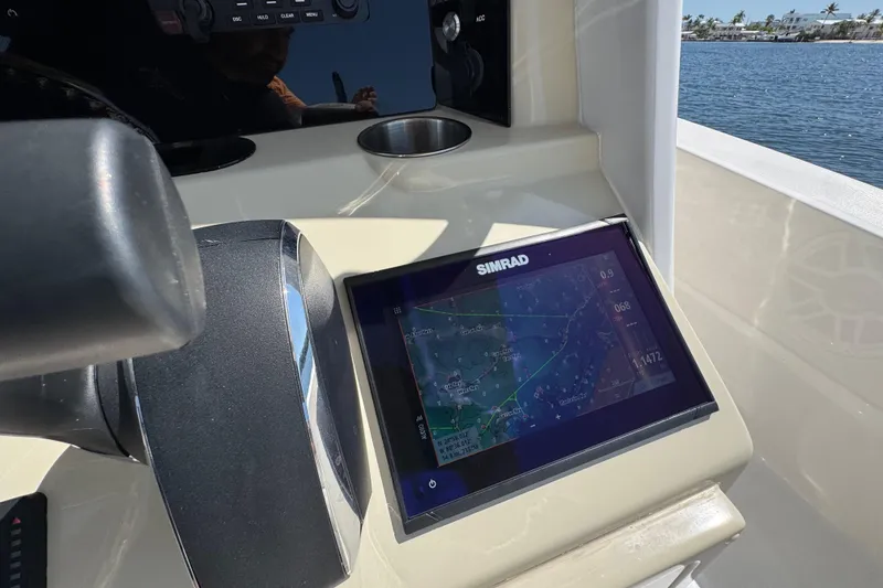 Slide: The Image of Simrad navigation display on 2025 Blackwater 23 Bay boat dashboard, near water. - 43