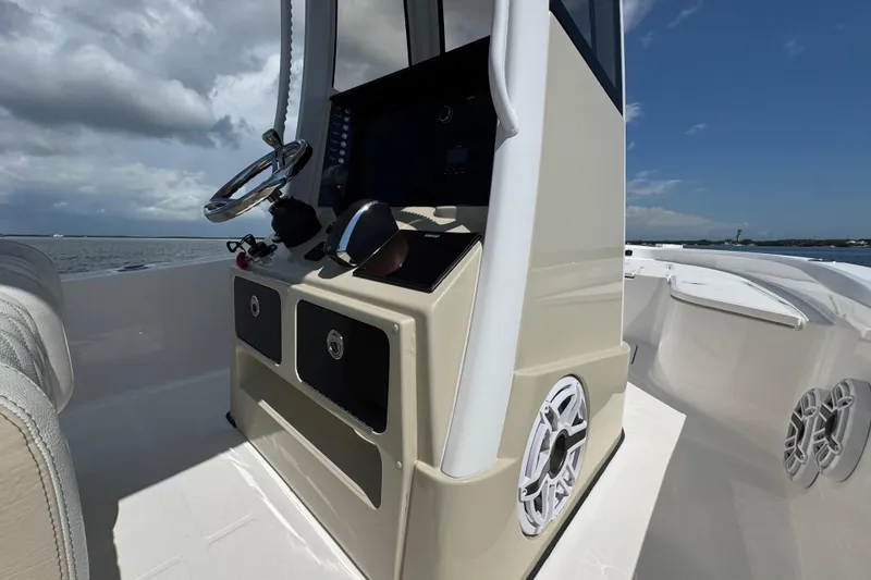 Slide: The Image of 2025 Blackwater 23 Bay boat console with steering wheel and storage compartments. - 47