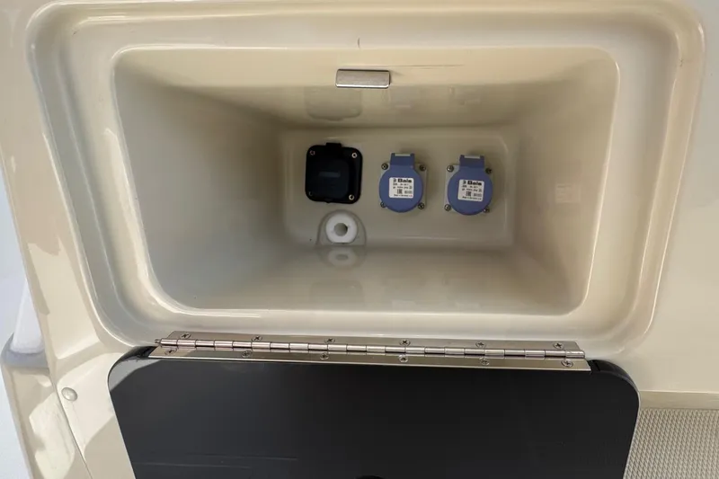 Slide: The Image of Compartment of 2025 Blackwater 23 Bay boat with electrical outlets and storage space. - 50