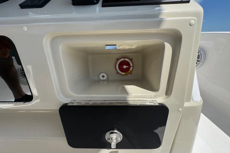 Slide: The Image of 2025 Blackwater 23 Bay boat compartment with control knob and storage space. - 51