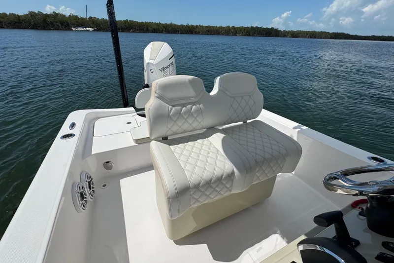 Slide: The Image of 2025 Blackwater 23 Bay boat interior with plush seating and scenic water view. - 52