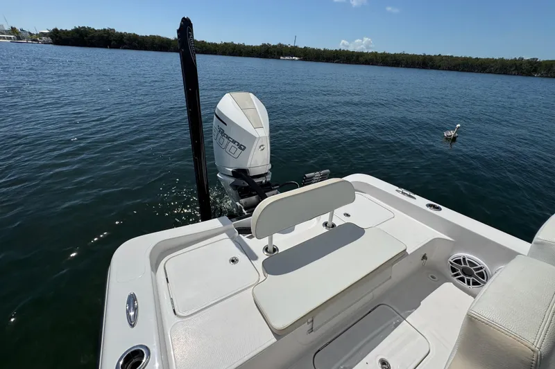 Slide: The Image of 2025 Blackwater 23 Bay boat on calm water, featuring a powerful outboard motor. - 57
