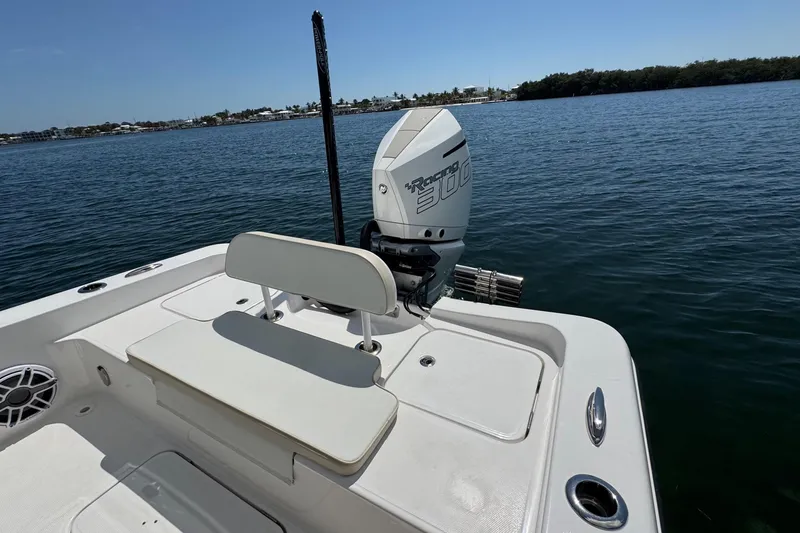 Slide: The Image of 2025 Blackwater 23 Bay boat with powerful outboard motor on calm water. - 58