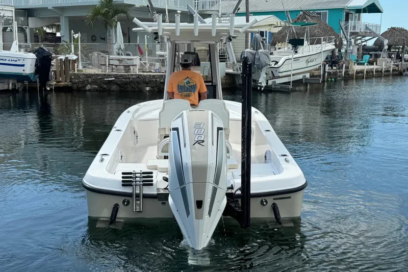 Slide: The Image of 2025 Blackwater 23 Bay boat docked in a scenic waterfront setting. - 6