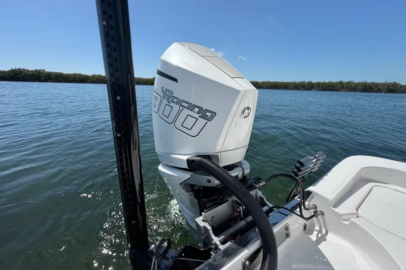 Slide: The Image of 2025 Blackwater 23 Bay boat with powerful outboard motor on calm water. - 66