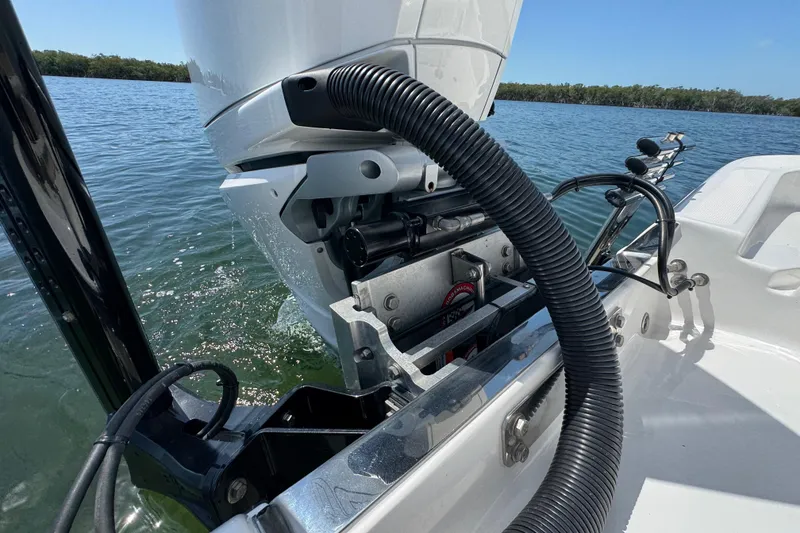 Slide: The Image of 2025 Blackwater 23 Bay boat engine detail on calm water. - 69