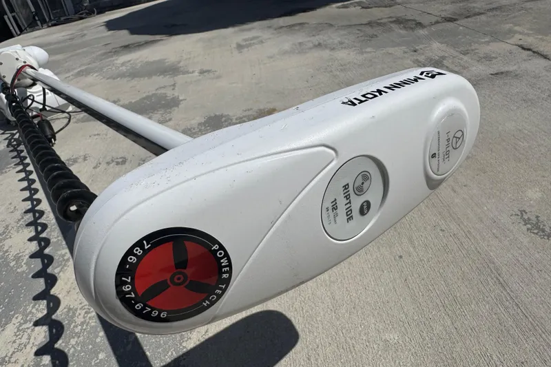 Slide: The Image of Minn Kota trolling motor on Blackwater 23 Bay, 2025 model, resting on concrete surface. - 77