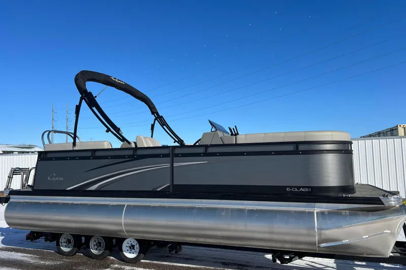 The Image of 2024 Qwest 8520 DH RLS LT pontoon boat on trailer under clear blue sky. - 0