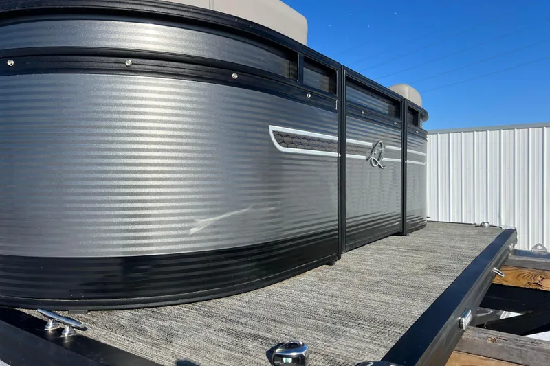 Slide: The Image of 2024 Qwest 8520 DH RLS LT pontoon boat with sleek metallic exterior design. - 10
