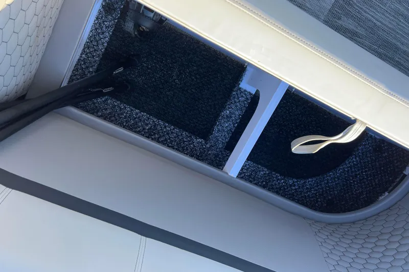 Slide: The Image of 2024 Qwest 8520 DH RLS LT boat interior storage compartment with carpeted flooring. - 19