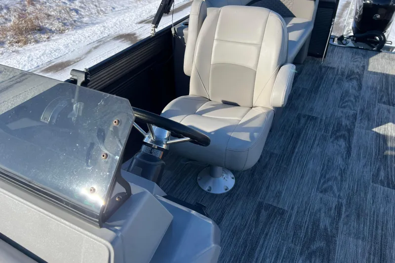 Slide: The Image of 2024 Qwest 8520 DH RLS LT boat interior with steering wheel and captain's chair. - 27