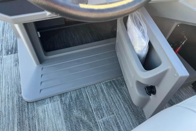 Slide: The Image of 2024 Qwest 8520 DH RLS LT boat storage compartment with gray interior and carpeted flooring. - 33