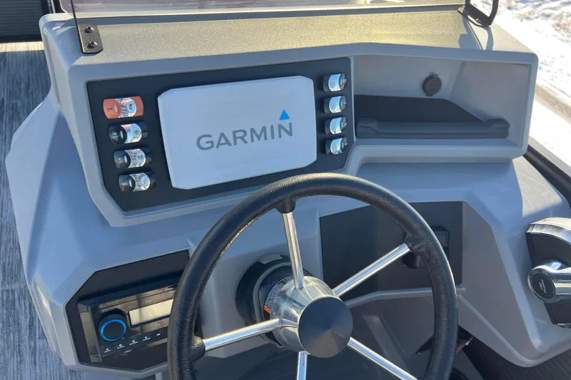 Slide: The Image of 2024 Qwest 8520 DH RLS LT boat dashboard with Garmin navigation system and steering wheel. - 35