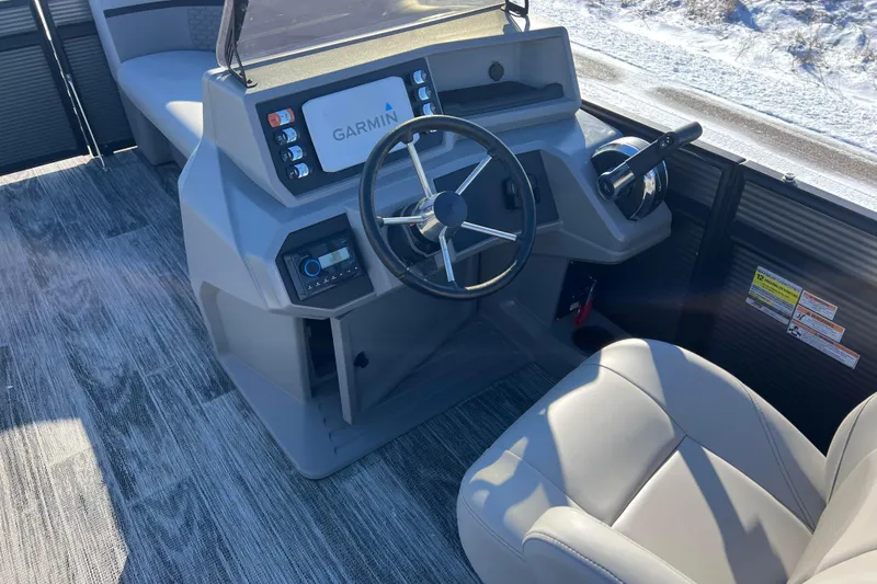 Slide: The Image of 2024 Qwest 8520 DH RLS LT boat dashboard with Garmin display and steering wheel. - 39