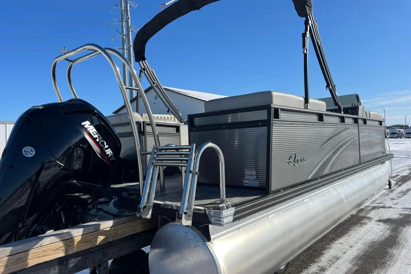 Slide: The Image of 2024 Qwest 8520 DH RLS LT pontoon boat with Mercury engine, parked on snowy ground. - 4
