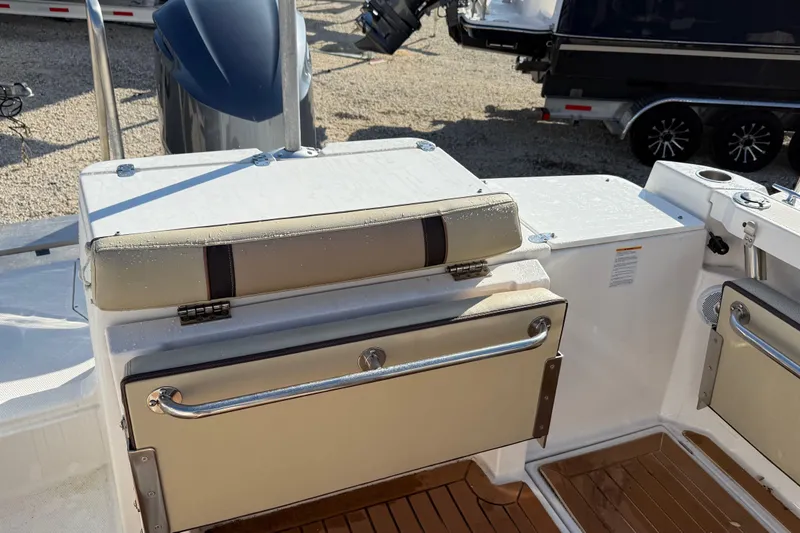 Slide: The Image of 2019 Ranger Tugs R-27 boat interior with cushioned seating and storage compartments. - 3