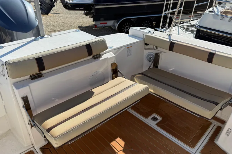 Slide: The Image of 2019 Ranger Tugs R-27 boat interior with foldable seating and teak flooring. - 4