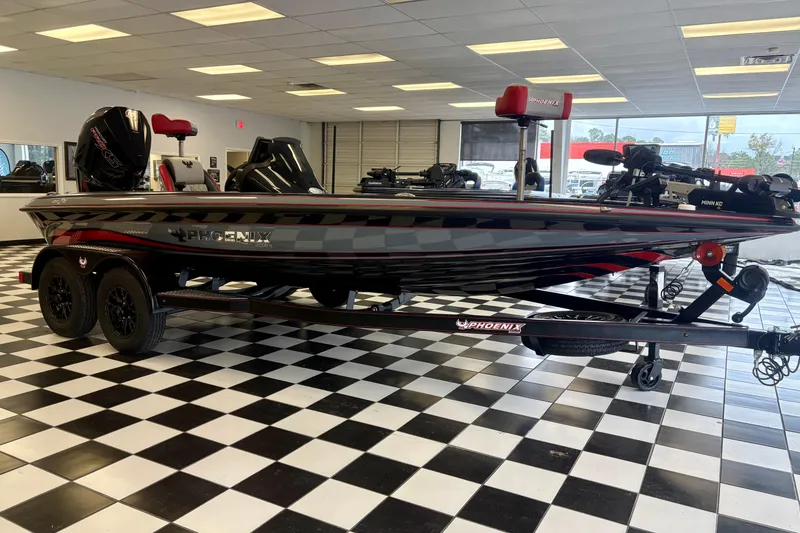 The Image of 2026 Phoenix 819 ZXL boat in showroom, black and red design, on checkered floor. - 1