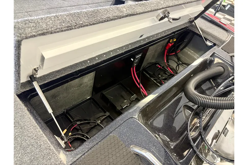 Slide: The Image of Open battery compartment of 2026 Phoenix 819 ZXL boat with visible wiring and components. - 13