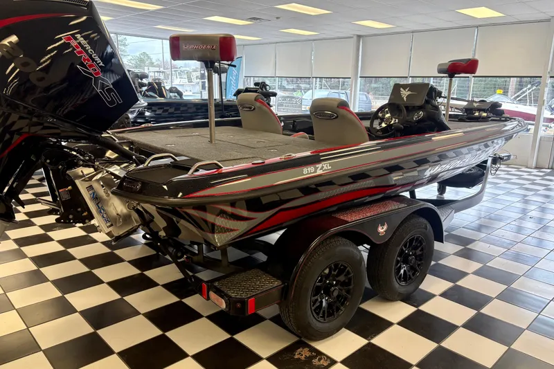 Slide: The Image of 2026 Phoenix 819 ZXL boat in showroom, featuring sleek design and powerful Mercury Pro XS engine. - 18