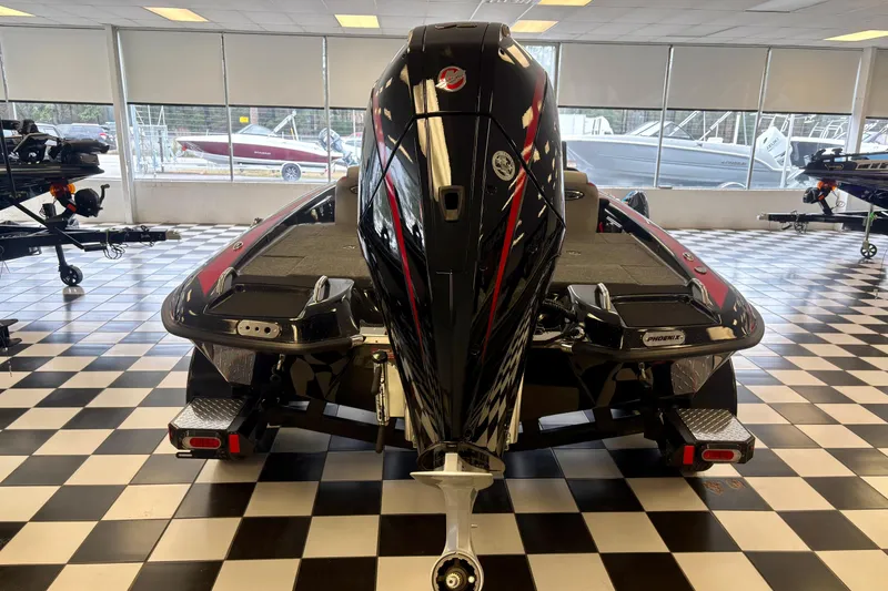 Slide: The Image of 2026 Phoenix 819 ZXL boat in showroom, checkered floor, rear view with motor. - 19