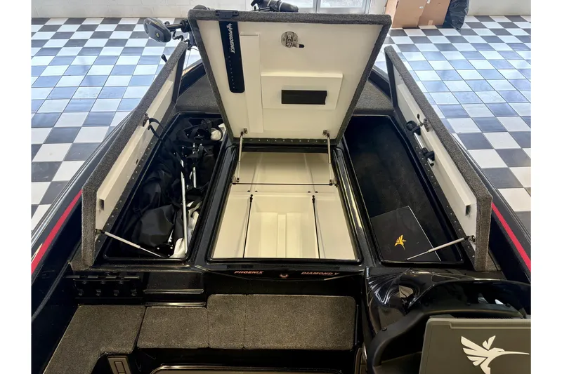 Slide: The Image of 2026 Phoenix 819 ZXL boat interior with open storage compartments on checkered floor. - 8