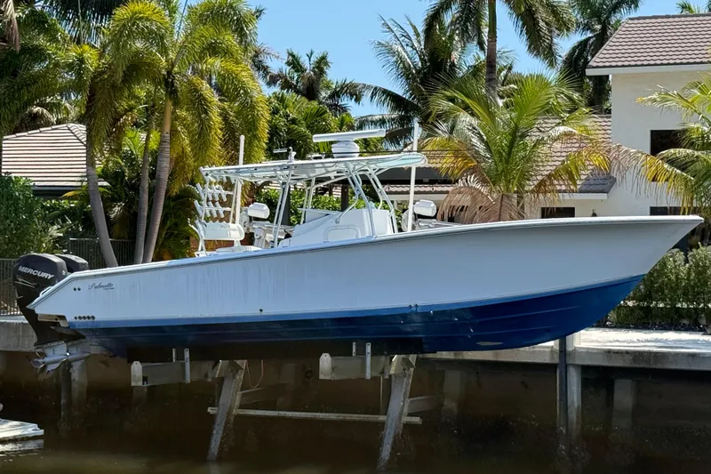 The Image of 2003 Palmetto 33 Adventure boat docked near tropical palm trees. - 1