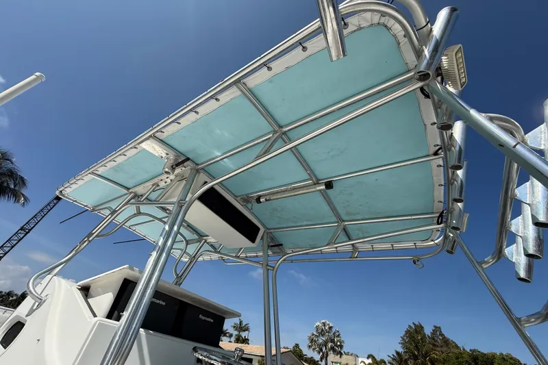 Slide: The Image of 2003 Palmetto 33 Adventure boat with blue canopy and stainless steel frame. - 11