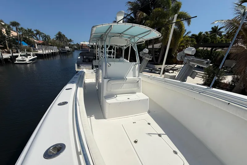 Slide: The Image of 2003 Palmetto 33 Adventure boat docked on a sunny canal with palm trees. - 6