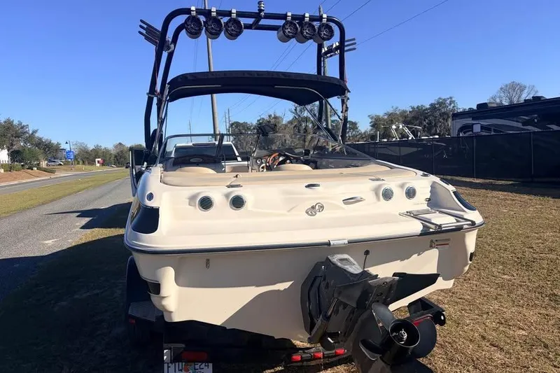 Slide: The Image of 2004 Larson LXH 190 I/O boat, rear view with wakeboard tower and lights. - 3