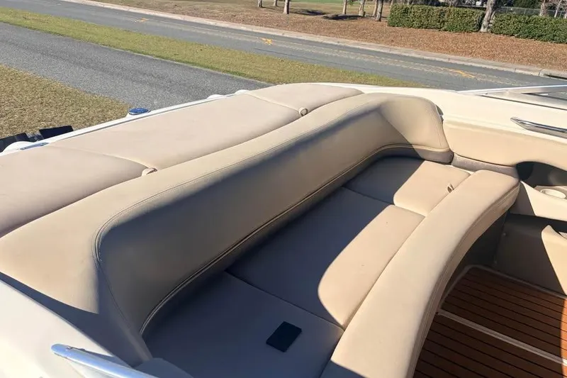 Slide: The Image of 2004 Larson LXH 190 I/O boat interior with beige seating and wooden flooring. - 7