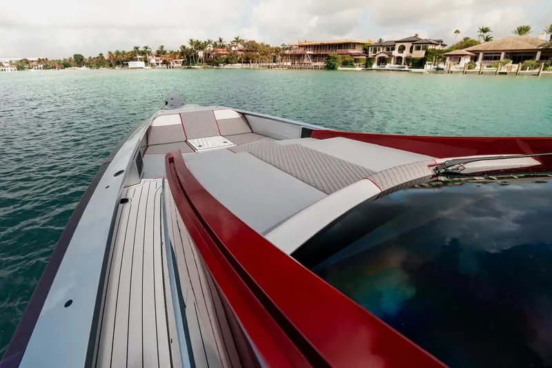 Slide: The Image of 2025 Maori 54XL luxury yacht on serene water near coastal homes. - 11