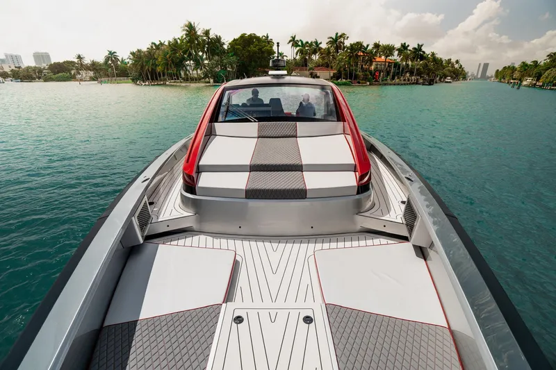 Slide: The Image of Luxurious 2025 Maori 54XL yacht cruising on turquoise waters near palm-lined shore. - 13