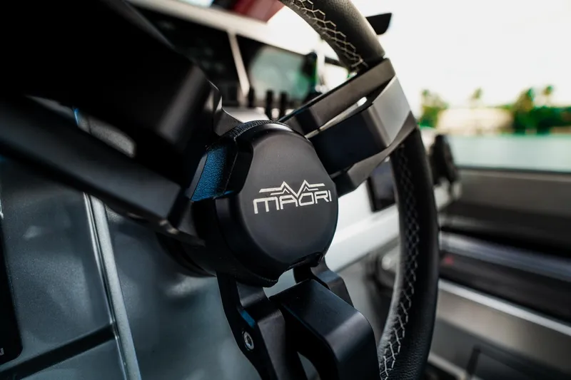 Slide: The Image of Close-up of Maori 54XL 2025 steering wheel, showcasing sleek design and logo. - 22