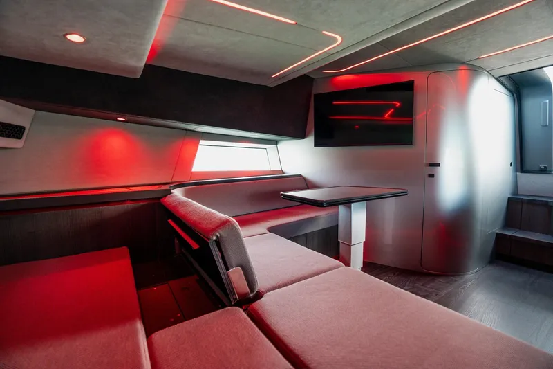 Slide: The Image of Modern interior of 2025 Maori 54XL yacht with sleek design and ambient red lighting. - 27
