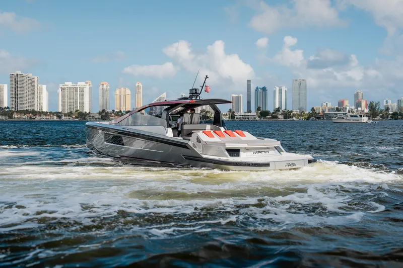 Slide: The Image of Luxury Maori 54XL yacht cruising near city skyline, 2025 model. - 3