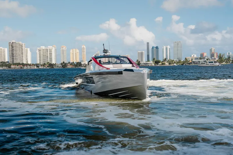 Slide: The Image of Luxury Maori 54XL yacht cruising near city skyline, 2025 model. - 4