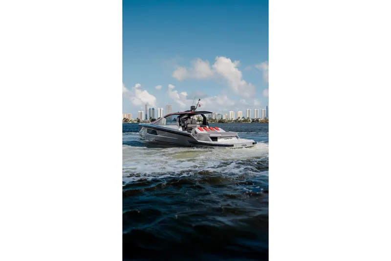 Slide: The Image of Luxury Maori 54XL yacht cruising on water, city skyline in background, 2025 model. - 5